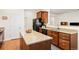 Spacious kitchen boasts granite counters, an island, stainless appliances, and wood cabinets at 4894 Bierstadt Loop, Broomfield, CO 80023