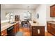 Open kitchen with granite countertops, hardwood floors, and island with space for seating at 4894 Bierstadt Loop, Broomfield, CO 80023