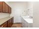 A convenient laundry room offers ample cabinet space, counter space, and modern appliances at 4894 Bierstadt Loop, Broomfield, CO 80023