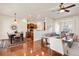 Open living space with hardwood floors, a dining area, and a view into the kitchen at 4894 Bierstadt Loop, Broomfield, CO 80023