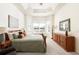 Serene main bedroom with a tray ceiling, bay window, and stylish dresser and lamps at 4894 Bierstadt Loop, Broomfield, CO 80023