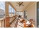 A spacious screened in porch features comfortable seating and beautiful natural light at 4894 Bierstadt Loop, Broomfield, CO 80023