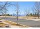 Scenic street view with bare trees and a glimpse of the mountain view in the distance at 4894 Bierstadt Loop, Broomfield, CO 80023