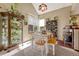 Cozy dining area with white table, wooden bench, and display cabinet at 2134 S Scranton Way, Aurora, CO 80014