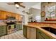 Galley kitchen with stainless steel appliances and wood cabinets at 2134 S Scranton Way, Aurora, CO 80014