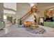 Open living room with vaulted ceiling, staircase, and large windows at 2134 S Scranton Way, Aurora, CO 80014