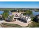 Aerial view of a lakeside property featuring a circular driveway and lush landscaping at 9833 Shoreline Dr, Longmont, CO 80504