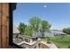 Scenic backyard featuring an outdoor kitchen, lake view, and lush greenery at 9833 Shoreline Dr, Longmont, CO 80504
