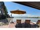 Lakeside backyard offering a relaxing view with lounge chairs and an umbrella at 9833 Shoreline Dr, Longmont, CO 80504