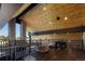 Upper-level balcony with wood ceilings, stone columns, iron railing, and an exterior view at 9833 Shoreline Dr, Longmont, CO 80504