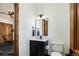 Bathroom with dark wood door, vanity, and toilet at 9833 Shoreline Dr, Longmont, CO 80504