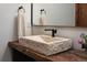 Modern bathroom featuring a stone vessel sink, sleek black faucet, and rustic wooden countertop at 9833 Shoreline Dr, Longmont, CO 80504