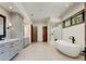 Bathroom featuring a soaking tub, shower, double vanity, and tiled floors at 9833 Shoreline Dr, Longmont, CO 80504
