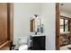 Charming powder room featuring a black vanity with marble countertop and wood trim at 9833 Shoreline Dr, Longmont, CO 80504