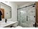 Elegant bathroom featuring a frameless glass shower with black fixtures and marble tile at 9833 Shoreline Dr, Longmont, CO 80504