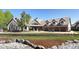 Beautiful home with a large circular driveway, manicured lawn and stone retaining wall at 9833 Shoreline Dr, Longmont, CO 80504