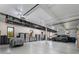 Spacious garage with epoxy flooring, ample storage cabinets, and a vehicle lift at 9833 Shoreline Dr, Longmont, CO 80504
