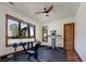 Workout room with large window, gym equipment, and fan at 9833 Shoreline Dr, Longmont, CO 80504