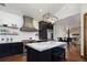 Spacious kitchen boasts stainless steel appliances, a large island, and flows into a dining area with fireplace at 9833 Shoreline Dr, Longmont, CO 80504