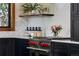 Modern kitchen features stainless steel oven with red knobs, floating shelves, and white countertops at 9833 Shoreline Dr, Longmont, CO 80504