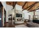 Open-concept living room features vaulted ceilings, exposed beams, and a cozy fireplace at 9833 Shoreline Dr, Longmont, CO 80504