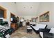 Cozy living room featuring a fireplace, tile flooring, and a wet bar area at 9833 Shoreline Dr, Longmont, CO 80504