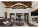 Spacious living room with vaulted ceilings, exposed wood beams, and stone fireplace at 9833 Shoreline Dr, Longmont, CO 80504