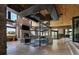 Spacious living room features stone walls, a fireplace, spiral staircase and view of the lake at 9833 Shoreline Dr, Longmont, CO 80504