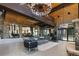 Open living room with stone accent walls, fireplace, spiral staircase, lake view, and modern furnishings at 9833 Shoreline Dr, Longmont, CO 80504