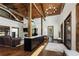 Open-concept living room with vaulted ceilings, hardwood floors, and a stone fireplace at 9833 Shoreline Dr, Longmont, CO 80504