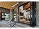 Indoor/outdoor living with stone fireplace and expansive windows in a luxury home at 9833 Shoreline Dr, Longmont, CO 80504