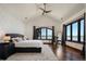 Bright main bedroom featuring a vaulted ceiling, lake views, and hardwood floors at 9833 Shoreline Dr, Longmont, CO 80504