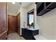 Functional mudroom with a utility sink, dark cabinets, and custom woodwork at 9833 Shoreline Dr, Longmont, CO 80504