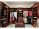 Walk-in closet with shelving, clothing racks, and ottoman at 9833 Shoreline Dr, Longmont, CO 80504