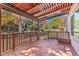 Back deck with pergola, wooden railings, and yard view at 5123 Red Oak Way, Parker, CO 80134