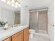 Basement bathroom, shower, toilet and wood vanity at 5123 Red Oak Way, Parker, CO 80134