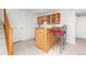 Basement wet bar with wood cabinets and red barstools at 5123 Red Oak Way, Parker, CO 80134