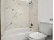 Updated bathroom with a bathtub and marble-style tile at 8678 Decatur St # 288, Westminster, CO 80031