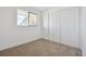 Bright bedroom with neutral walls, carpet, and double door closet at 8678 Decatur St # 288, Westminster, CO 80031