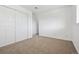 Well-lit bedroom featuring double-door closet and neutral carpeting at 8678 Decatur St # 288, Westminster, CO 80031