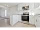 Modern kitchen with white cabinets, granite countertops, and stainless steel appliances at 8678 Decatur St # 288, Westminster, CO 80031