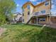 Spacious backyard with well-maintained lawn, patio, and deck, ideal for outdoor activities and relaxation at 3309 Springbriar Dr, Castle Rock, CO 80109
