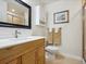 Bright bathroom featuring a wood vanity, white countertop, tiled shower, updated fixtures and a wall mirror at 3309 Springbriar Dr, Castle Rock, CO 80109