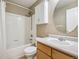 Clean bathroom featuring a shower-tub combination, wood vanity, and a neutral color scheme at 3309 Springbriar Dr, Castle Rock, CO 80109