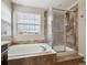 Modern bathroom showcasing a soaking tub with tile surround and a glass-enclosed shower for a luxurious experience at 3309 Springbriar Dr, Castle Rock, CO 80109