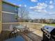 Relaxing deck with chairs, glass top table, a grill, and serene views of the neighborhood at 3309 Springbriar Dr, Castle Rock, CO 80109