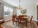 Elegant dining room with hardwood floors, chandelier, and a large window at 3309 Springbriar Dr, Castle Rock, CO 80109