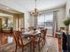 Elegant dining room with hardwood floors, chandelier, and a large window at 3309 Springbriar Dr, Castle Rock, CO 80109