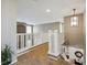 Bright hallway with white railings, carpeted floor, and decorative light fixture, leading to the home's various spaces at 3309 Springbriar Dr, Castle Rock, CO 80109
