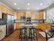 The sun-filled kitchen offers wood cabinetry, granite counters, stainless appliances and a center island with seating at 3309 Springbriar Dr, Castle Rock, CO 80109
